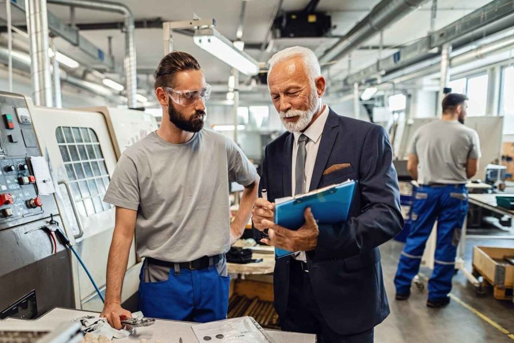 mature-engineer-young-worker-cooperating-while-going-through-paperwork-work-industrial-facility_637285-4154_11zon